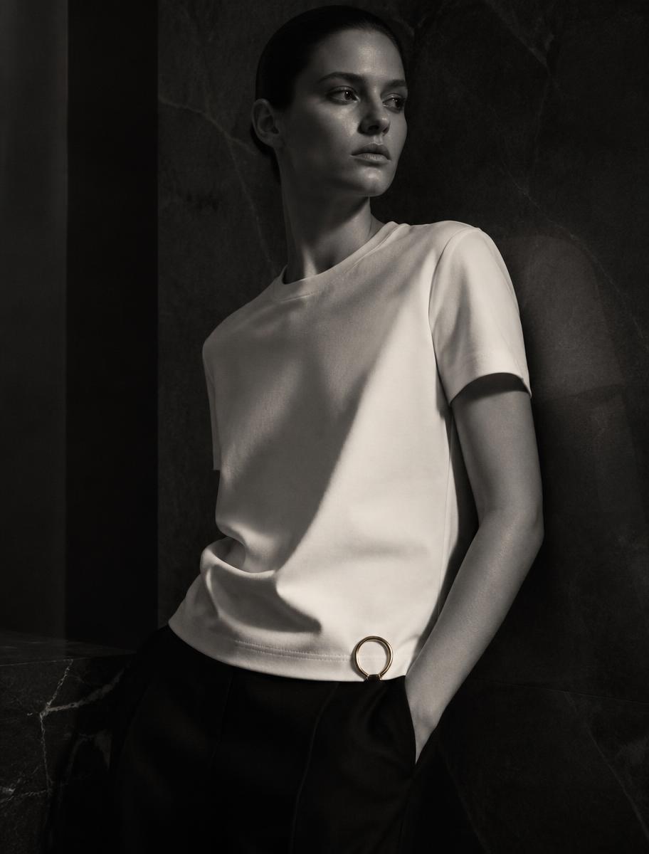 Model wearing an ivory heavyweight t-shirt with a platinum detail